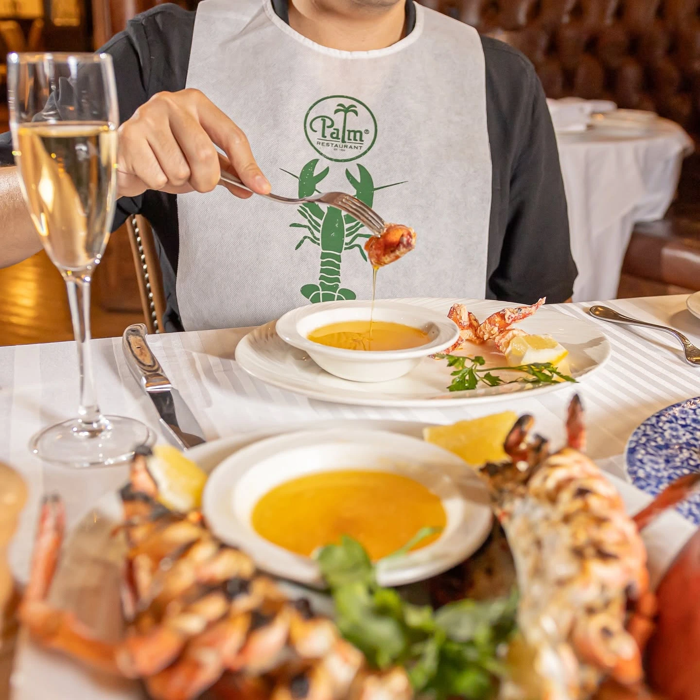A person eating lobster at the steakhouse The Palm in Polanco